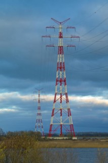 Red and white marked electricity pylons on the Lower Elbe near Stade