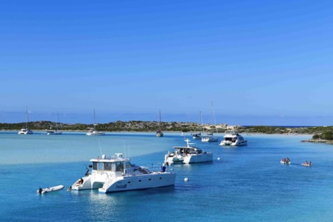 Sailboats and catamarans anchor off Warderick Wells