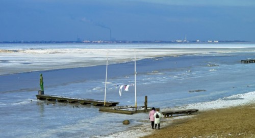View over the frozen Jade Bay towards Wilhelmshaven
