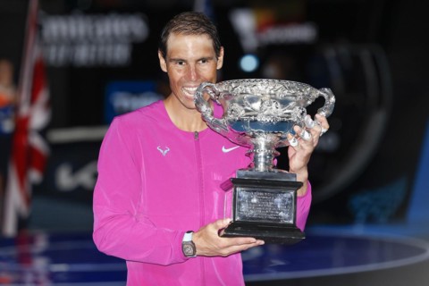Spanish tennis player Rafael Nadal posing with the championship trophy after winning the mens singles final match of the Australian Open 2022