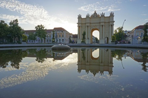 Reflection Brandenburg Gate in water basin