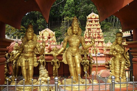 Three golden statues of gods
