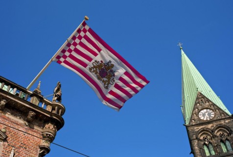 The Bremen Town Hall with a cathedral tower and the Bremen flag