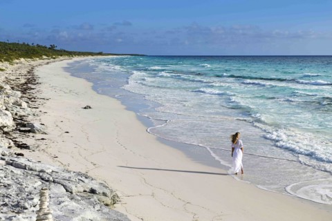 Tourist on the beach of Highbourne Cay