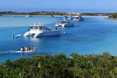 Sailboats and catamarans anchor off Warderick Wells