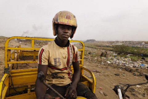 Young man at the textile dump in Accra