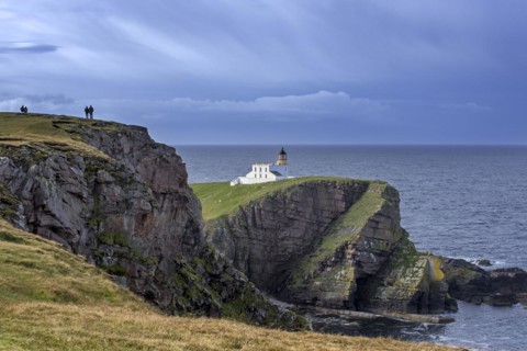 Walkers and the Stoer Head Lighthouse at the Point of Stoer in Sutherland