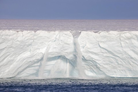 Waterfalls at edge of the Brasvellbreen glacier from the ice cap Austfonna debouching into the Barents Sea
