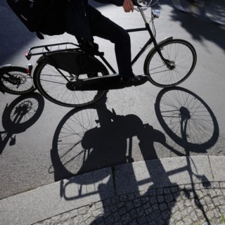Symbolic photo on the subject of cycling in the city. Cyclists ride on the bicycle lane in Linienstrasse in Berlin Mitte. Berlin