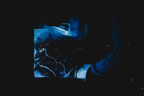 A metal worker welds metal