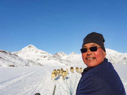 Inuit on dog sleds on Kong Oskar Fjord