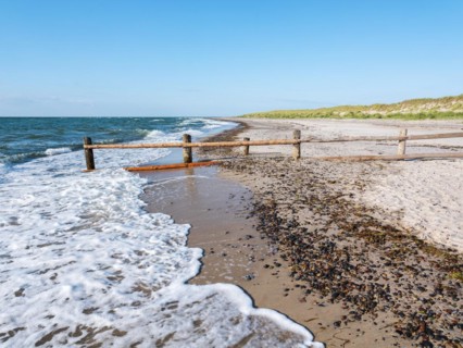 Fence on the beach of the Baltic Sea as the border of the closed-off core zone of the National Park Vorpommersche Boddenlandschaft
