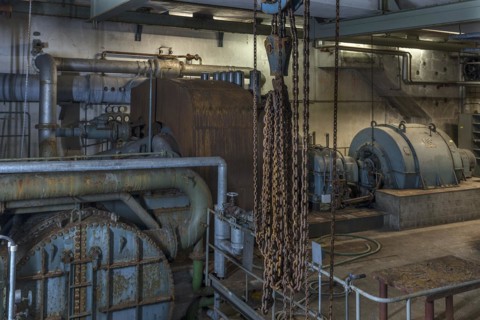 Chains from a pulley block in the pump room of a former paper factory