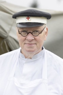 Volunteer of the Red Cross presents a historical outfit