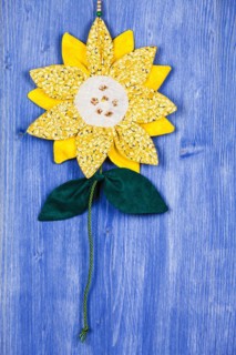 Fabric sunflower on blue background