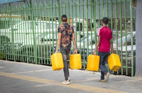 Men with water canisters. Street scene in Addis Ababa