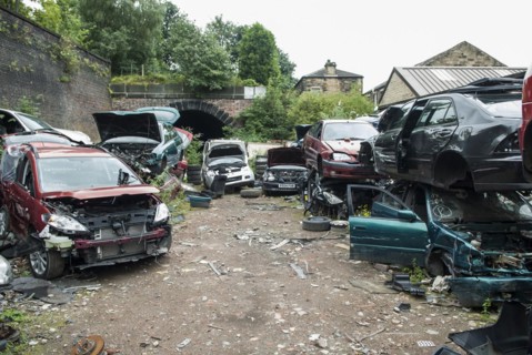 Crushed cars in scrap yard UK