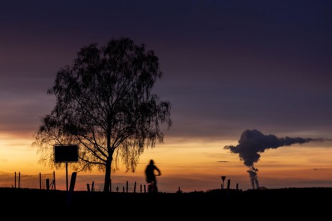The Schwarze Pumpe coal-fired power plant looms in the evening twilight near Ober-Prauske