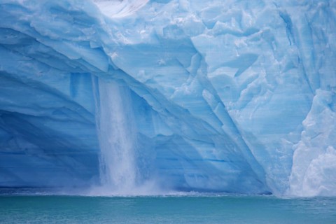 Waterfall at edge of the Brasvellbreen glacier from the ice cap Austfonna debouching into the Barents Sea