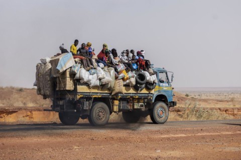 People sitting on a truck