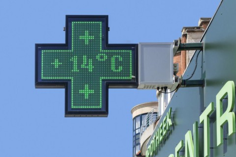 Thermometer in pharmacy screen sign displays extremely warm temperature of 14 degrees Celsius