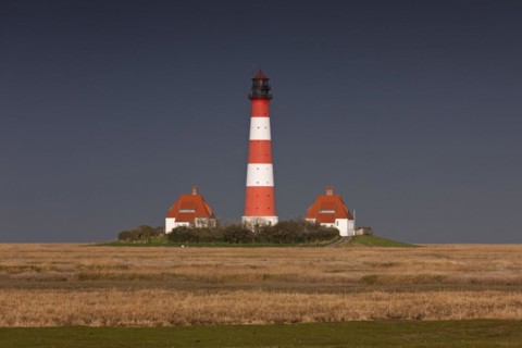 Dark rain cloud rolling in over lighthouse Westerheversand at Westerhever
