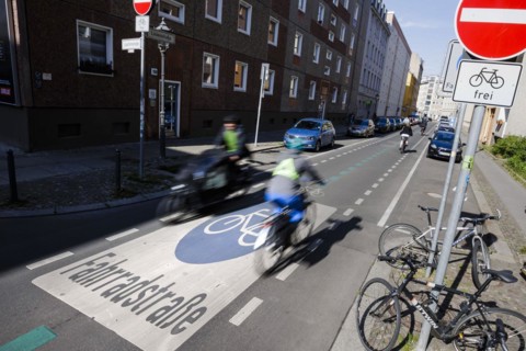 Symbolic photo on the subject of bicycle lanes in the city. Cyclists ride on the bicycle street in Linienstrasse in Berlin Mitte. Berlin