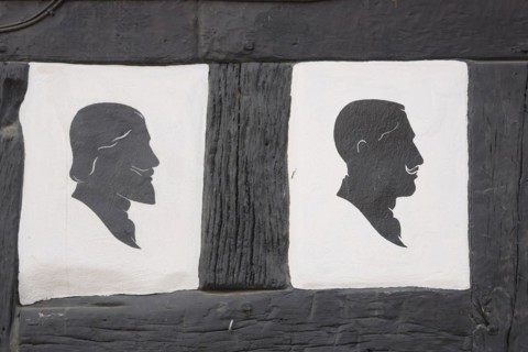 Two men's hairstyles at the half-timbered house of the hairdresser's salon