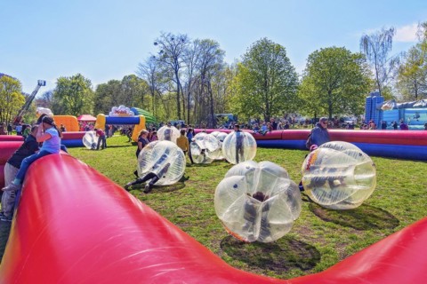 Children playing with inflatable plastic balls in springtime Luitpold Park