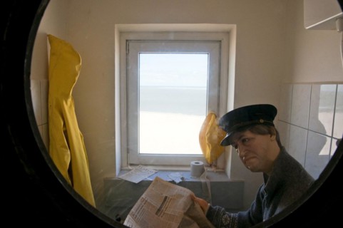 Dummy of lighthouse keeper reading the paper