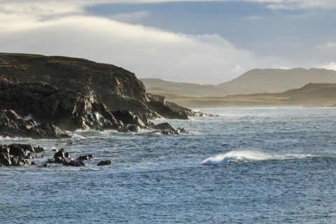Atmospheric light on the stormy rocky coast of western Scotland
