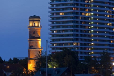 Maritim Hotel and the old lighthouse in the port of Travemuende at dusk