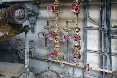 Rusty taps on water pipes of a former paper factory