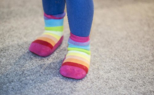 Colourful socks on the feet of a three-year-old child