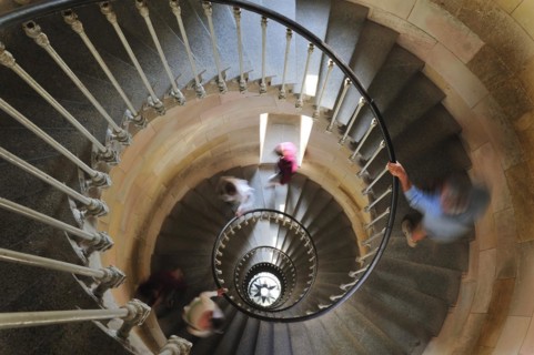 Tourists climbing spiral staircase inside the lighthouse Phare des Baleines on the island Ile de Re
