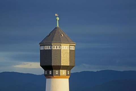 Water tower with light atmosphere in Kehl and mountains of the Black Forest