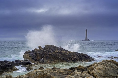 Wave crashing on rock and Phare de La Hague