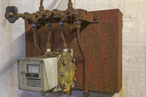 Rusted steam regulator of a former paper factory