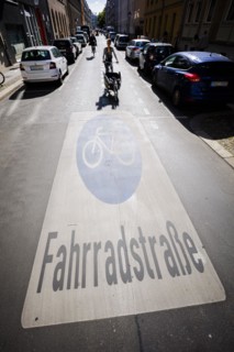 Symbolic photo on the subject of bicycle lanes in the city. Cyclists ride on the bicycle street in Linienstrasse in Berlin Mitte. Berlin