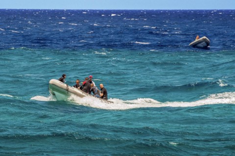 Rubber dinghies with divers in turquoise and blue water on Sanganeb Reef