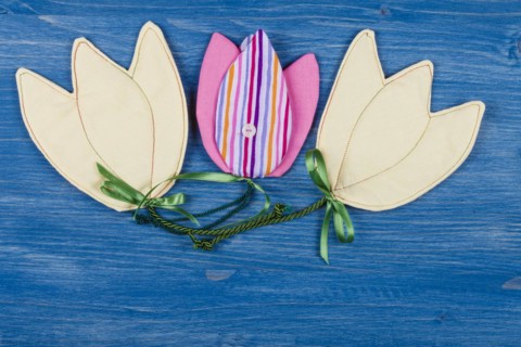 Three fabric tulips on a blue background