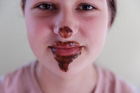 Girl with a chocolate-smeared mouth