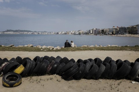An elderly couple sitting on the beach of Durres