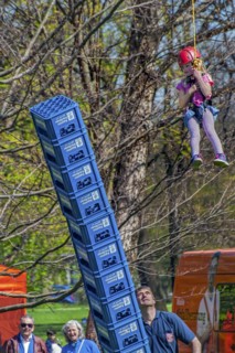 Child secured by rope falls while building tower out of beer crates