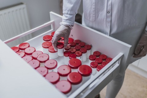 A prescription worker takes a TopTec Kruke from a drawer