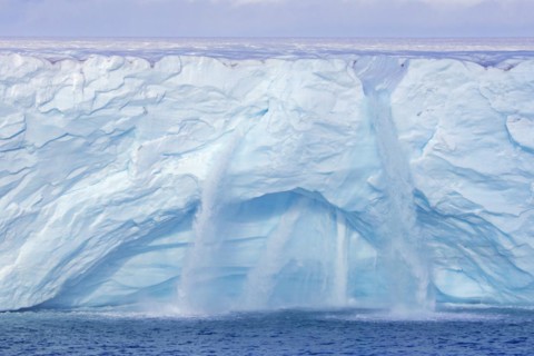 Waterfalls at edge of the Brasvellbreen glacier from the ice cap Austfonna debouching into the Barents Sea