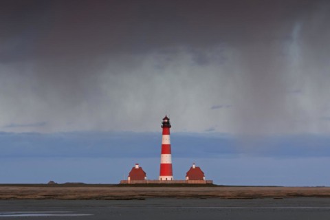 Downpour over the lighthouse Westerheversand at Westerhever