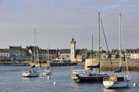 Sailing boats and lighthouse in the harbour of Roscoff