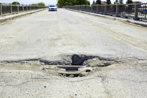 Bumpy road with pothole