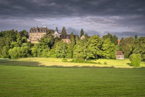 Eisenbach Castle and Annen Chapel under dark clouds